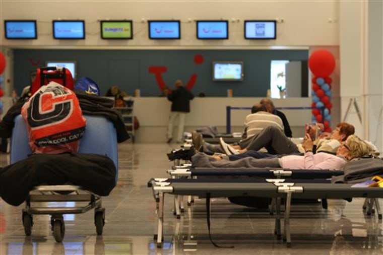 Passengers take a rest at Brussels airport on cots provided for them as all outgoing flights were canceled for the second day on April 16, due to Iceland’s spewing volcano.